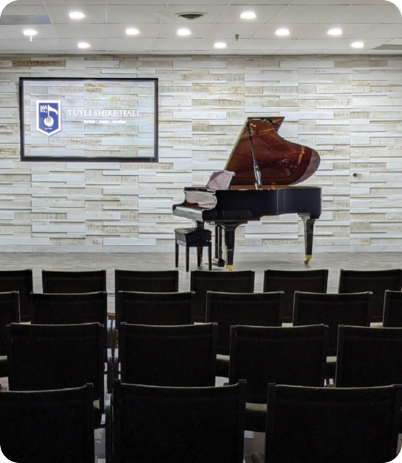 a piano on the stage of our music hall