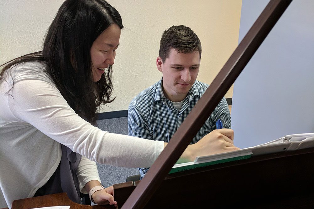 makcgallery_IMG_20180829_172835 a person playing the piano with an instructor