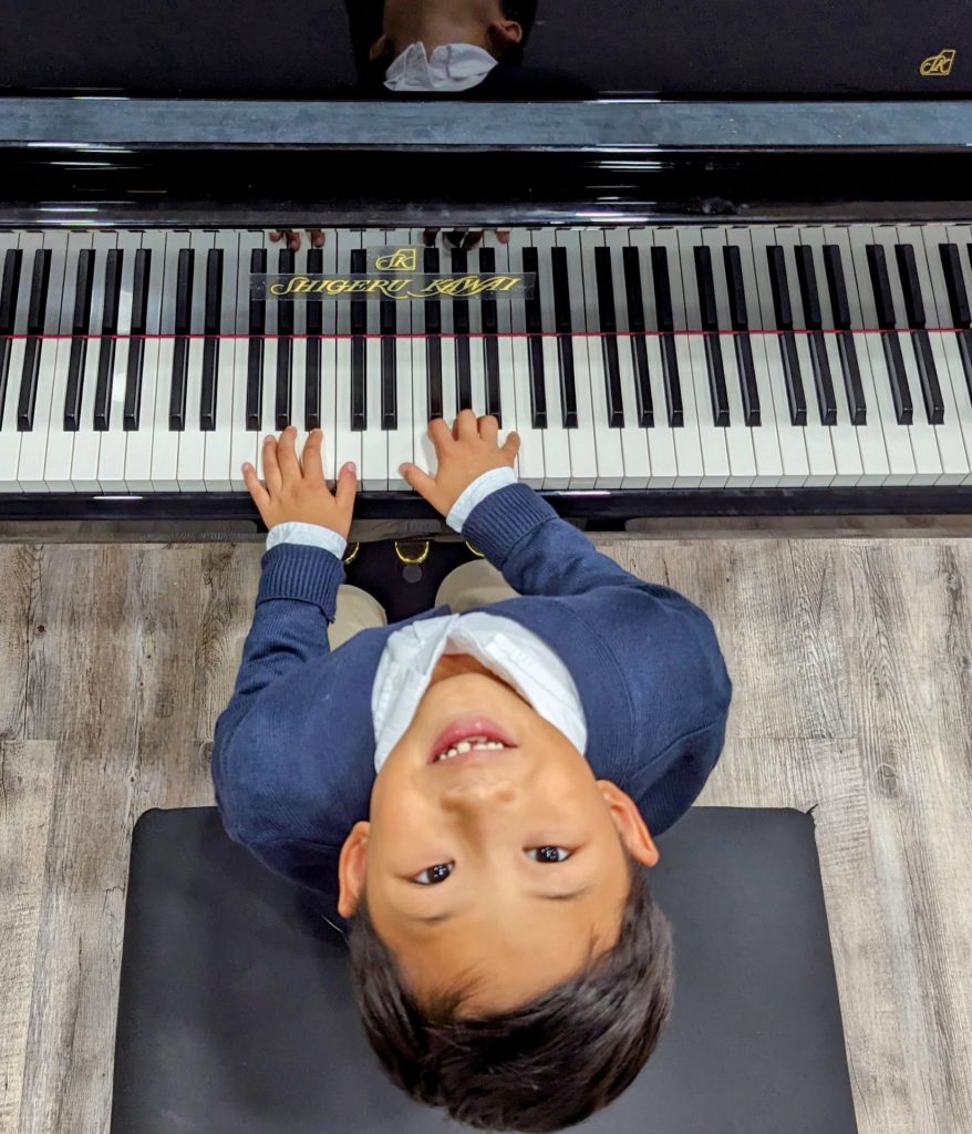 a young kid playing the piano